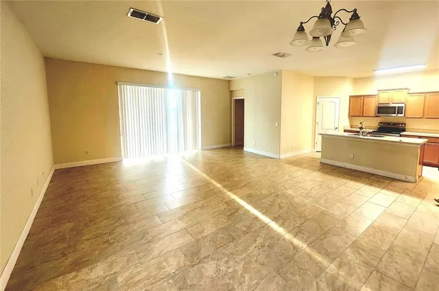 a view of a kitchen with kitchen island a sink wooden floor and a counter top space