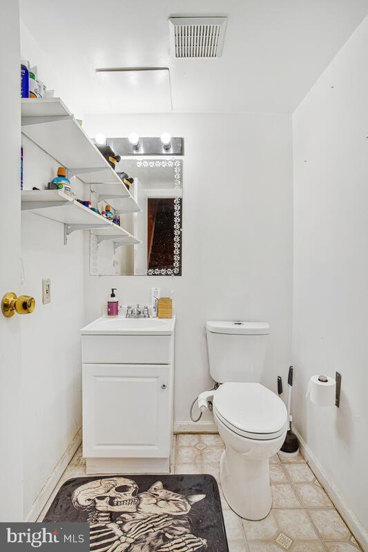 46 Cobber Lane Baltimore, MD 21229 - Photo 25 of 29 a bathroom with a sink toilet and wooden floor