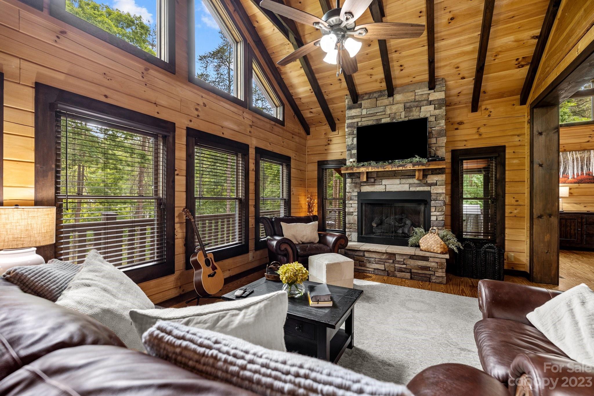 7478 Bankhead Road Denver, NC 28037 - Photo 14 of 48 a living room with furniture a fireplace a flat screen tv and a large window