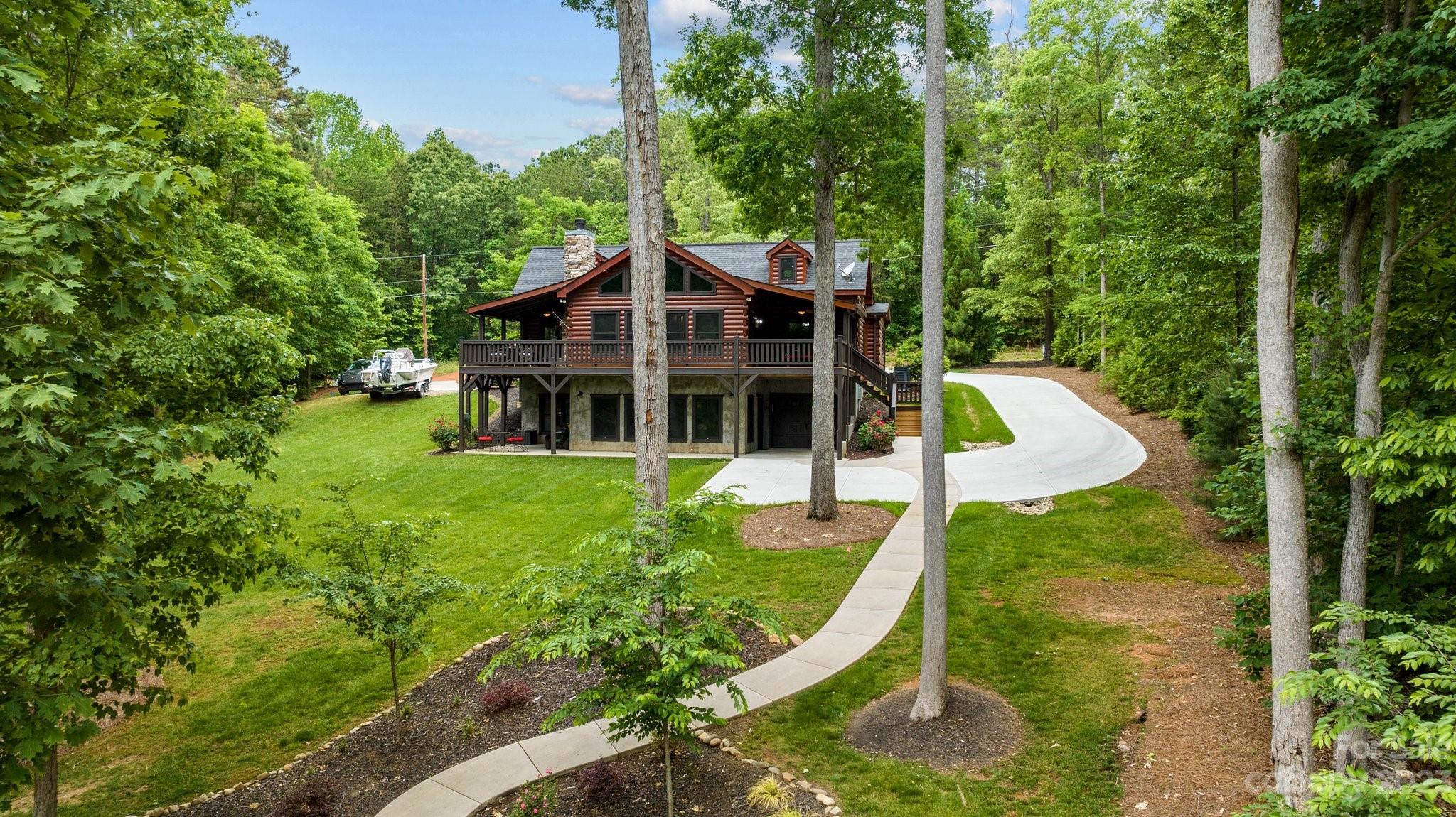 7478 Bankhead Road Denver, NC 28037 - Photo 2 of 48 a view of a house with a yard patio and a garden