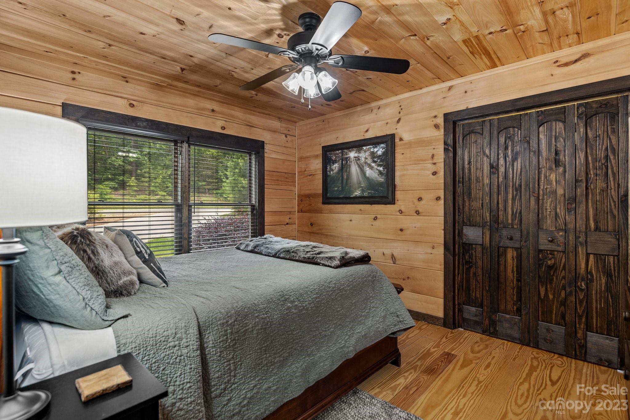 7478 Bankhead Road Denver, NC 28037 - Photo 23 of 48 a bedroom with a bed and a chandelier