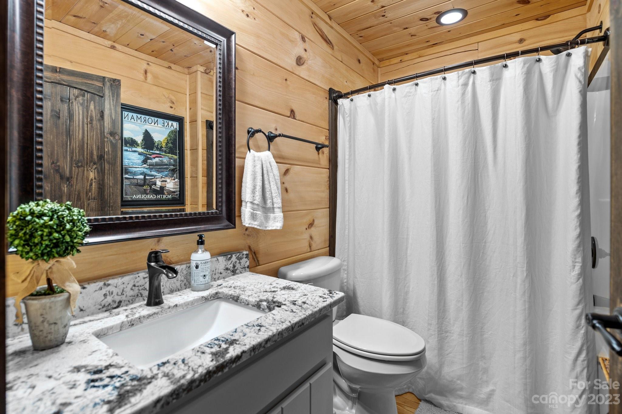 7478 Bankhead Road Denver, NC 28037 - Photo 25 of 48 a bathroom with a granite countertop sink and a mirror