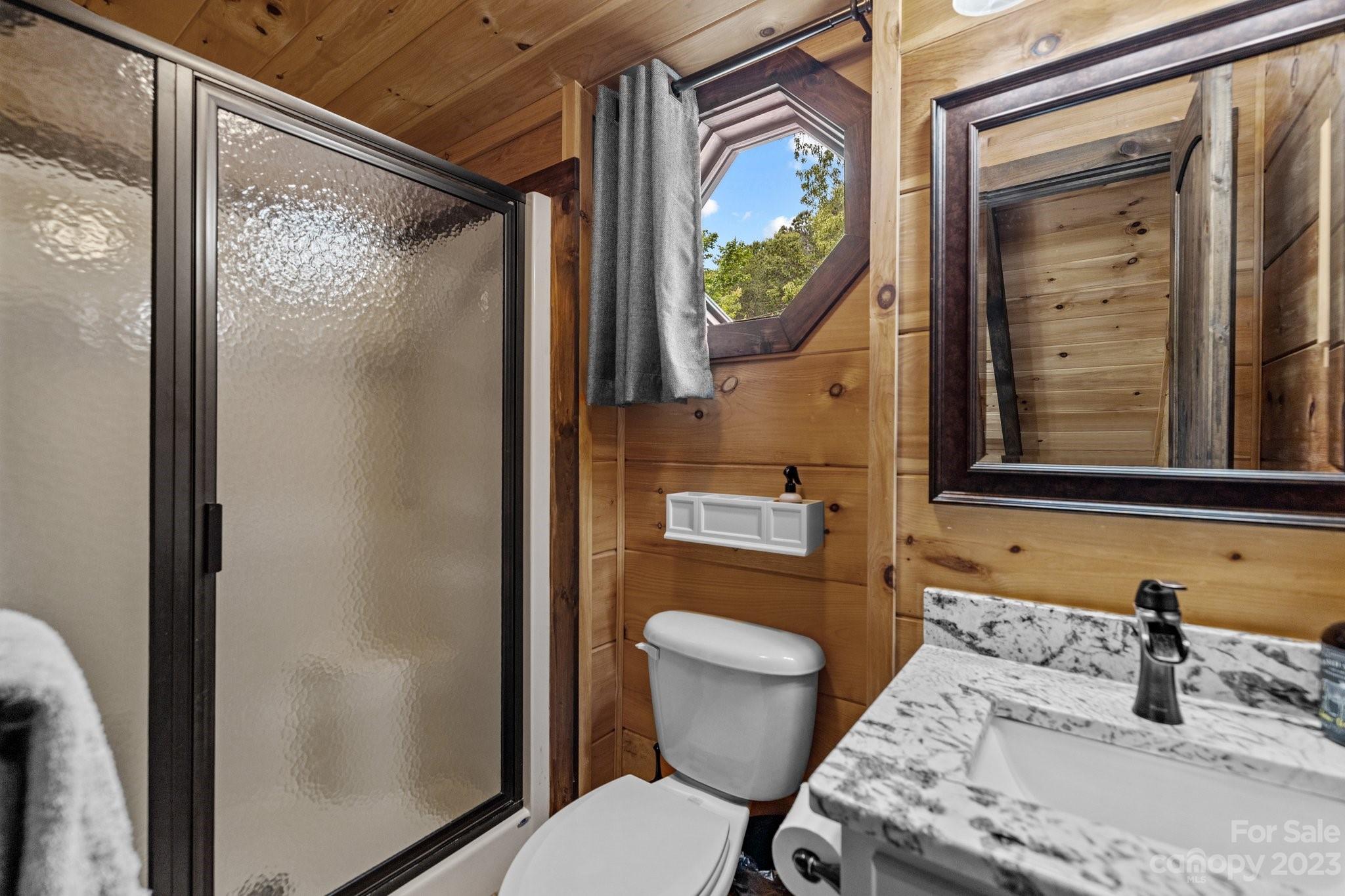 7478 Bankhead Road Denver, NC 28037 - Photo 30 of 48 a bathroom with a toilet sink and mirror