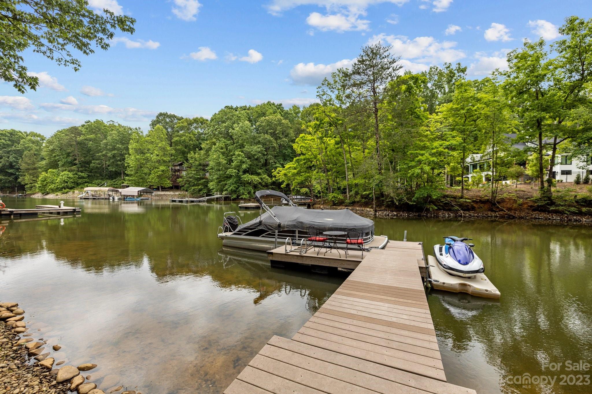 7478 Bankhead Road Denver, NC 28037 - Photo 45 of 48 a view of a lake with boats and trees in the background