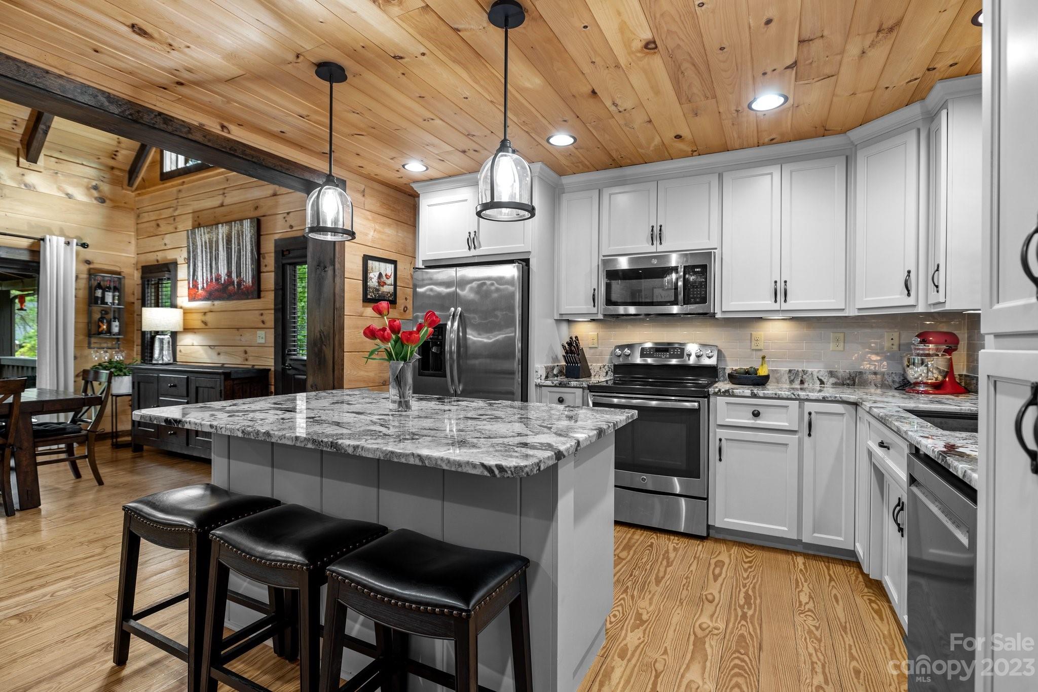 7478 Bankhead Road Denver, NC 28037 - Photo 7 of 48 a kitchen with stainless steel appliances granite countertop a stove sink refrigerator dining table and chairs
