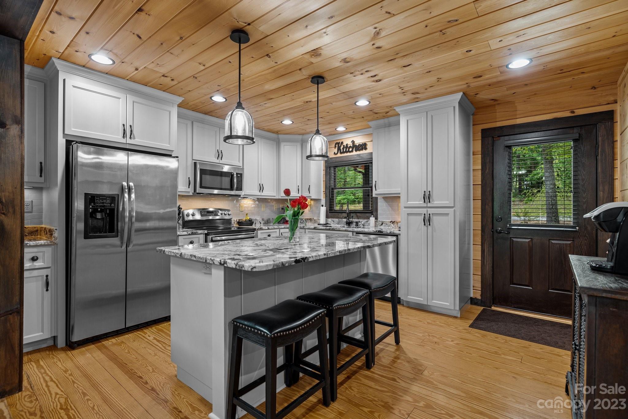 7478 Bankhead Road Denver, NC 28037 - Photo 8 of 48 a kitchen with stainless steel appliances granite countertop a refrigerator a oven a sink dishwasher and white cabinets with wooden floor