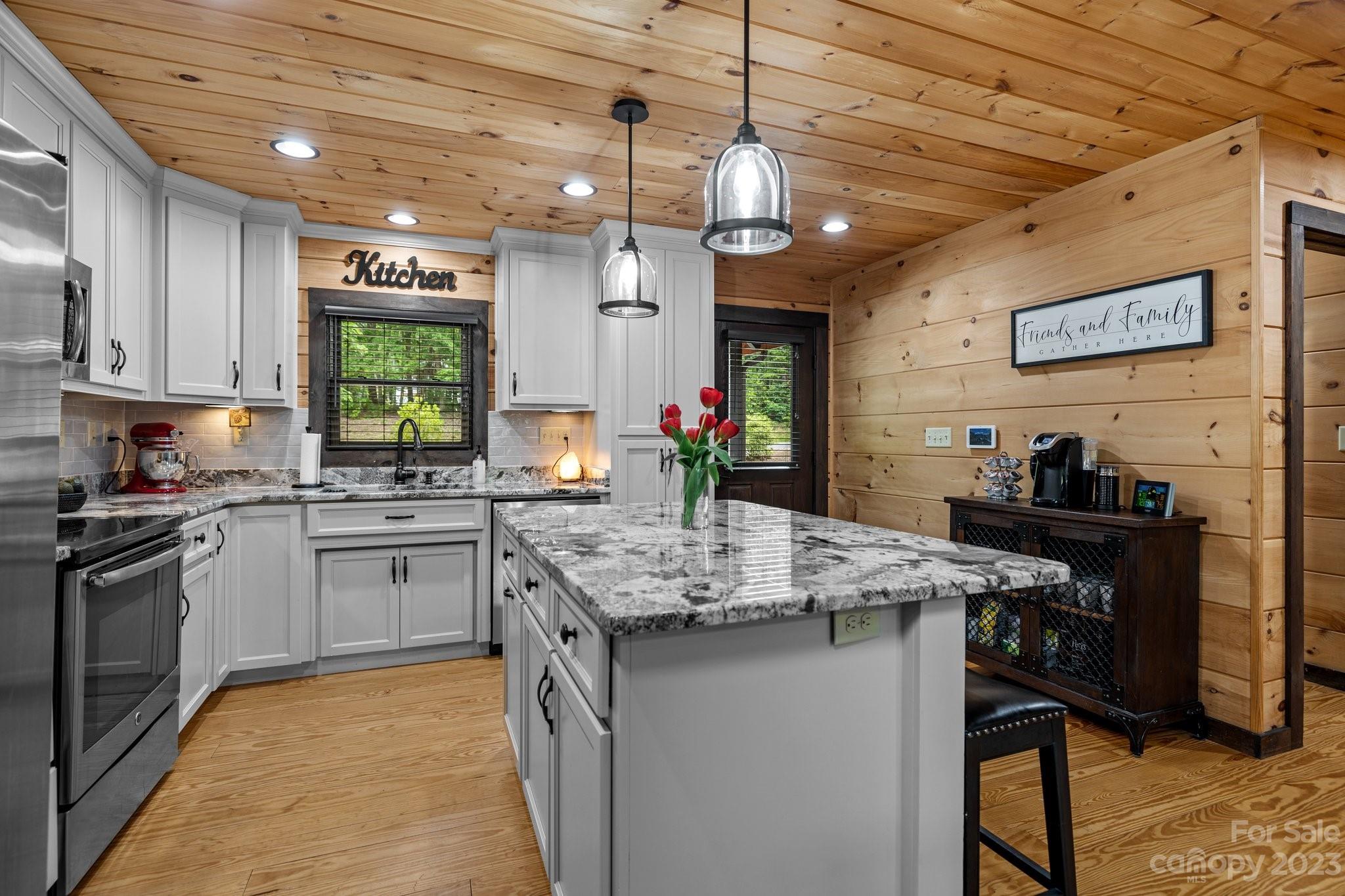 7478 Bankhead Road Denver, NC 28037 - Photo 9 of 48 a kitchen with stainless steel appliances granite countertop a stove top oven a sink dishwasher and a refrigerator with wooden floor