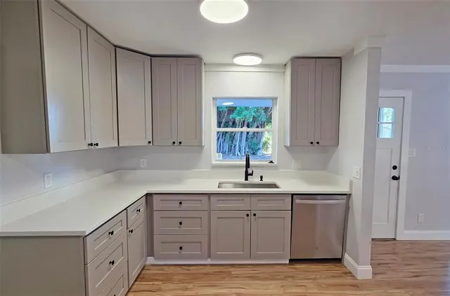 a kitchen with a sink and cabinets