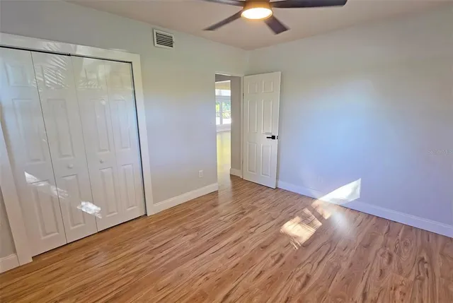 a view of empty room with wooden floor