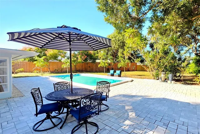 a view of a swimming pool with chair and table