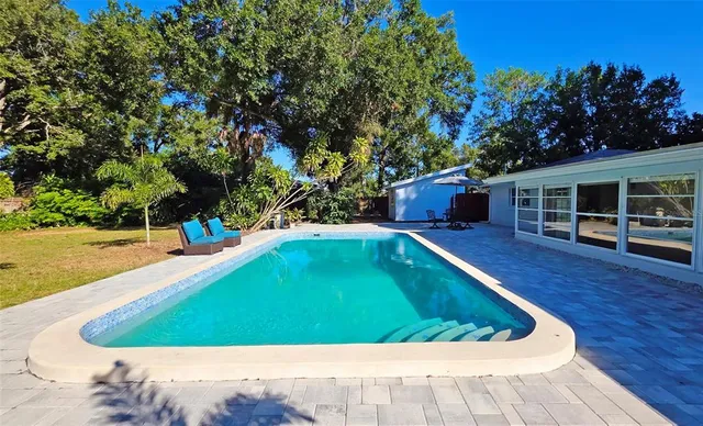a view of a swimming pool with an outdoor seating