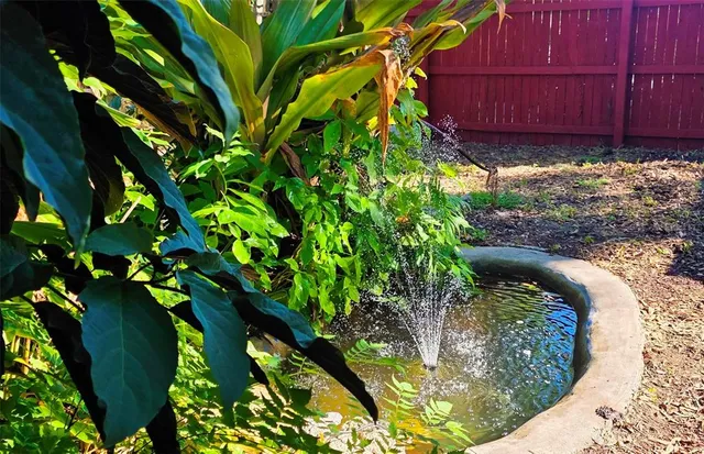 a view of yard with swimming pool and seating area