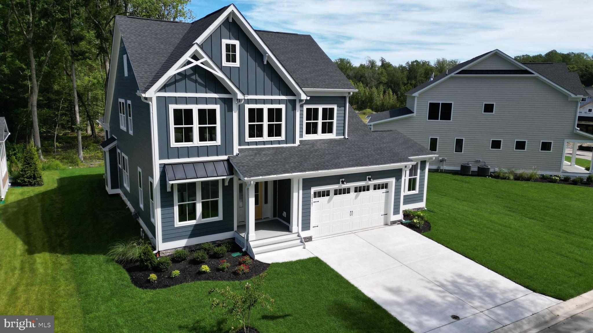 32354 Solara Way Lewes, DE 19958 - Photo 1 of 20 a front view of a house with a yard and trees