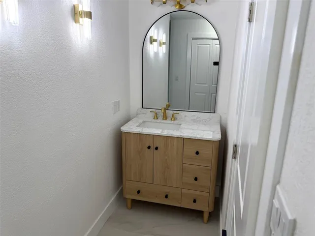 a bathroom with a double vanity sink and mirror
