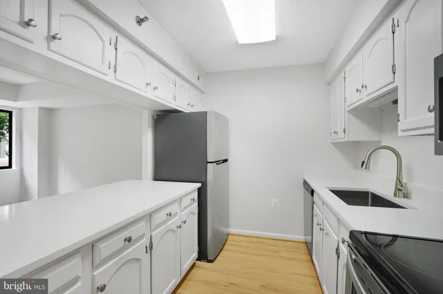 a kitchen with a sink and a refrigerator