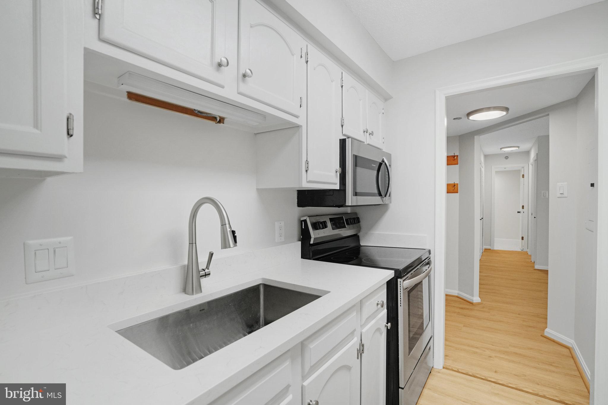 1301 North Courthouse Road, Unit 611 Arlington, VA 22201 - Photo 11 of 32 a kitchen with stainless steel appliances granite countertop a sink and a refrigerator