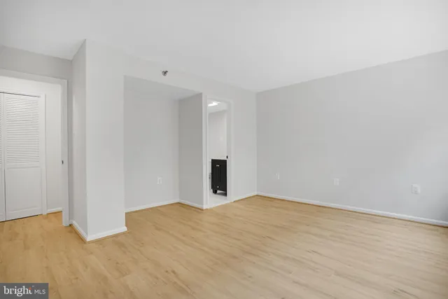 a view of an empty room with wooden floor