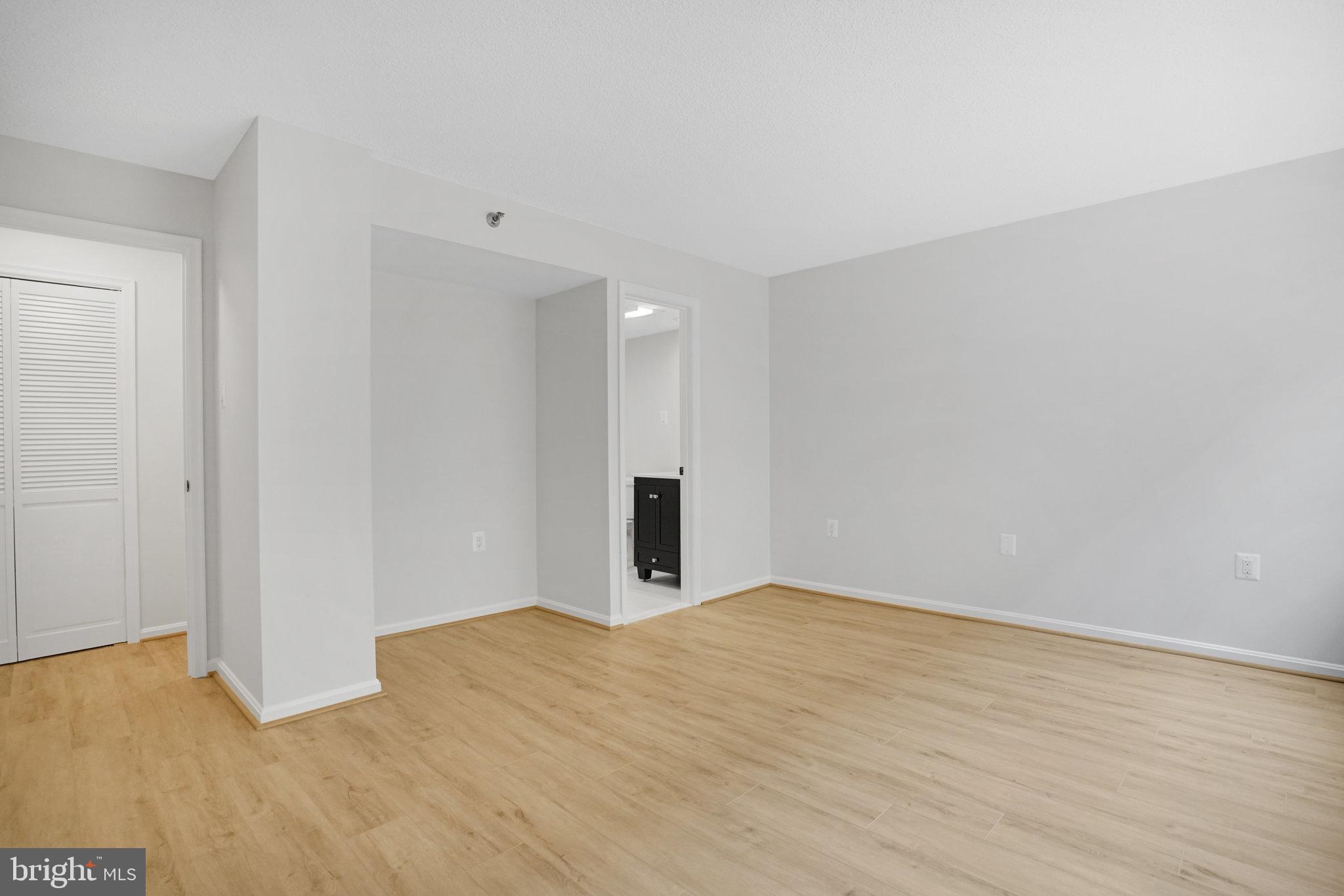 1301 North Courthouse Road, Unit 611 Arlington, VA 22201 - Photo 17 of 32 a view of an empty room with wooden floor