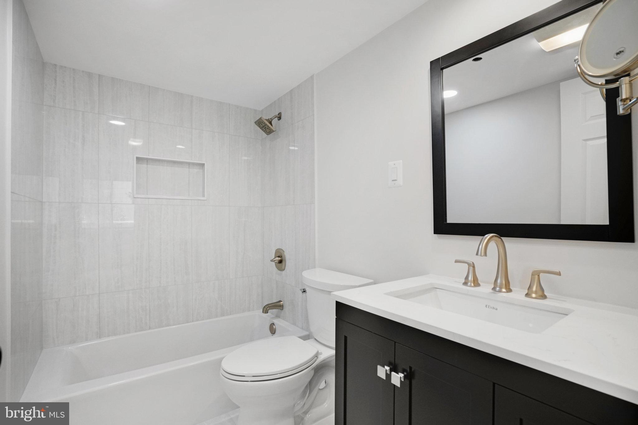 1301 North Courthouse Road, Unit 611 Arlington, VA 22201 - Photo 19 of 32 a bathroom with a granite countertop sink toilet and shower