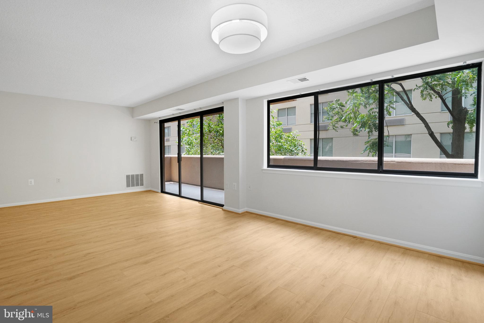1301 North Courthouse Road, Unit 611 Arlington, VA 22201 - Photo 5 of 32 an empty room with large windows
