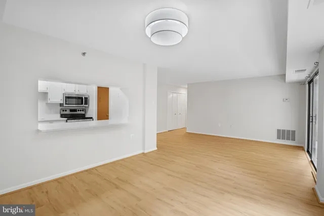 an empty room with large windows