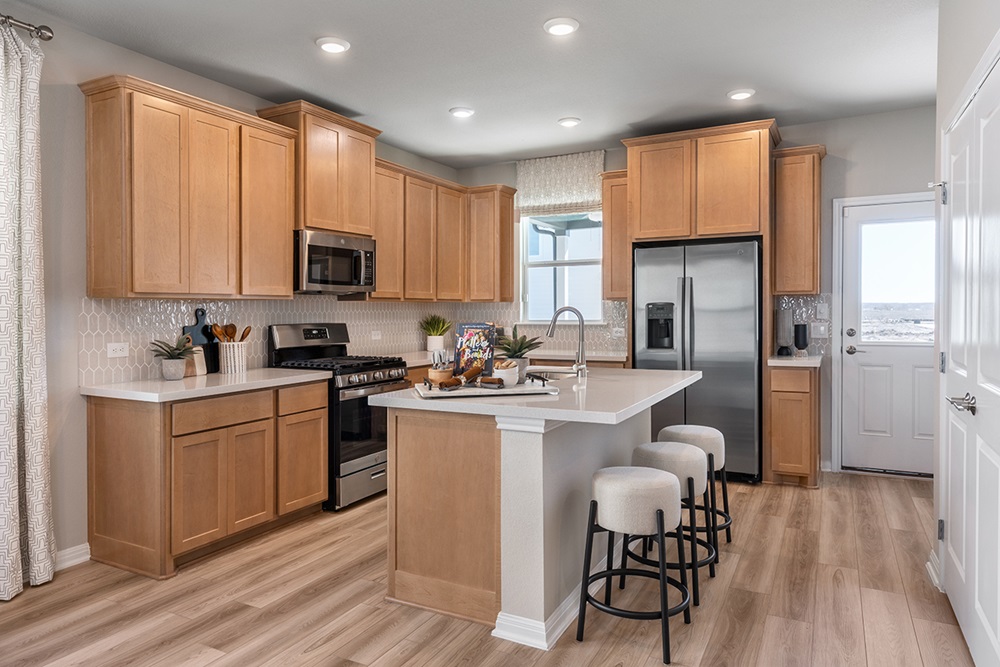 5905 Beverly Pr Road Del Valle, TX 78617 - Photo 12 of 18 a kitchen with stainless steel appliances granite countertop a refrigerator a stove top oven a sink dishwasher and white cabinets with wooden floor