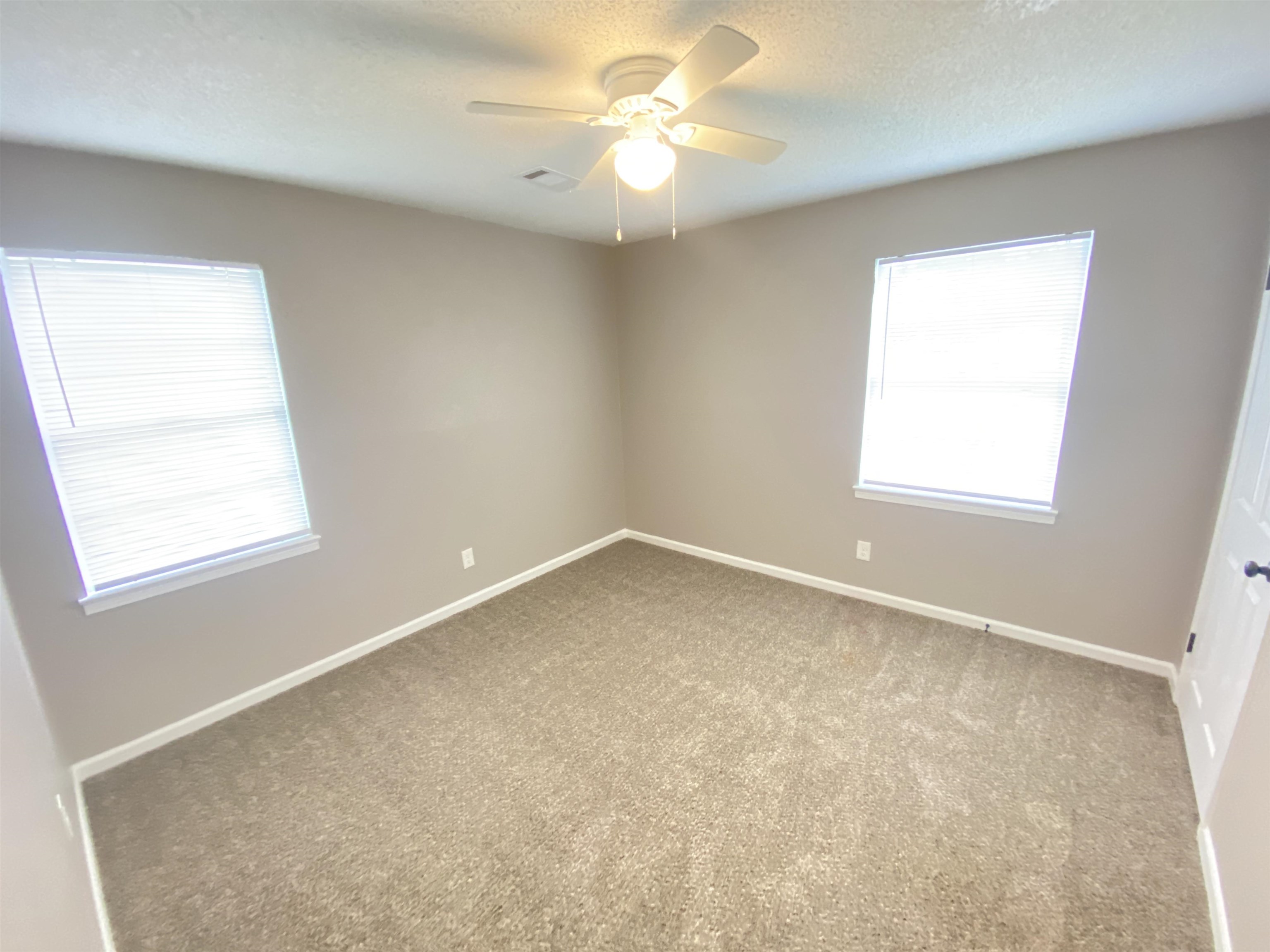2581 Callie Road Memphis, TN 38127 - Photo 5 of 13 an empty room with a window and a fan