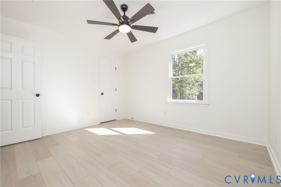 2311 Moseley Road Moseley, VA 23120 - Photo 28 of 50 an empty room with a window and a fan