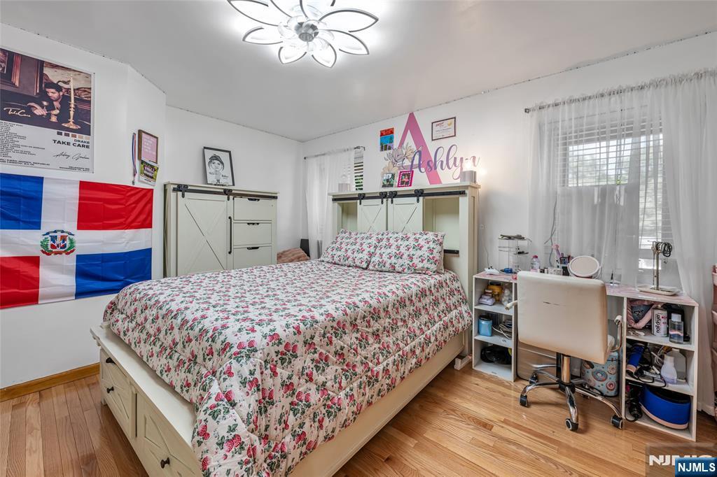 21 Marcia Road Ringwood, NJ 07456 - Photo 20 of 42 a bedroom with a bed and a chandelier