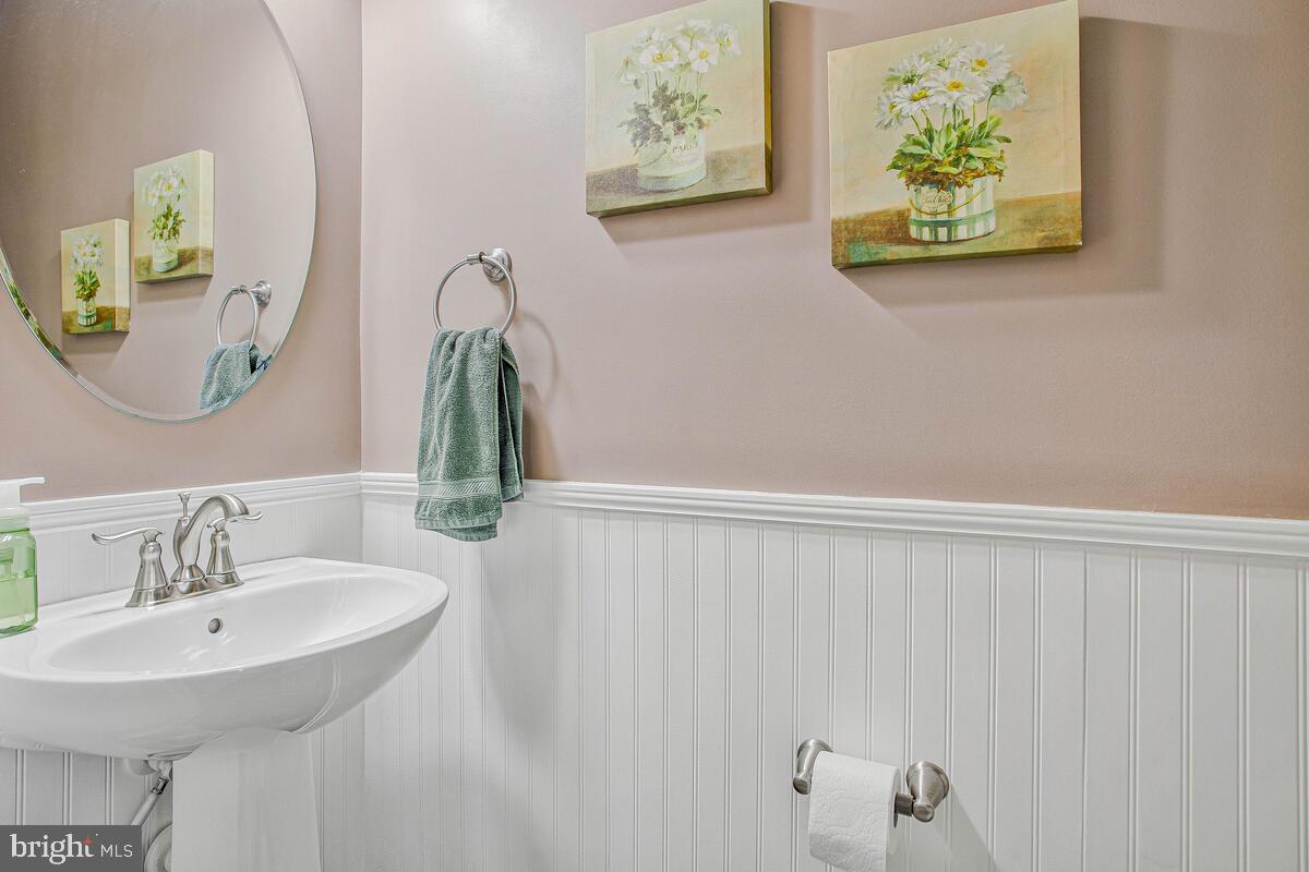 8218 Kippis Road Millersville, MD 21108 - Photo 15 of 40 a bathroom with a sink and a mirror