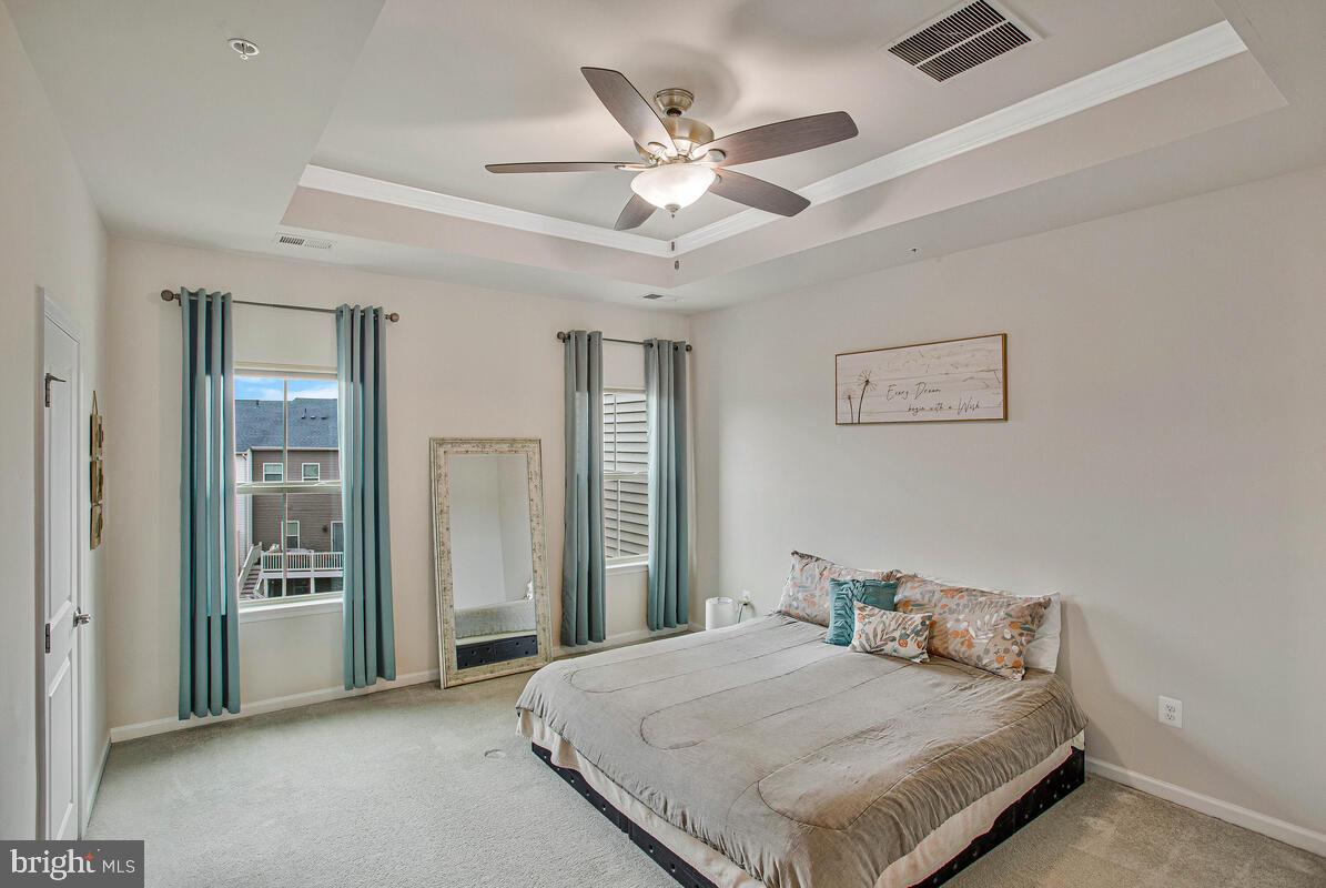 8218 Kippis Road Millersville, MD 21108 - Photo 16 of 40 a bedroom with a bed and a ceiling fan