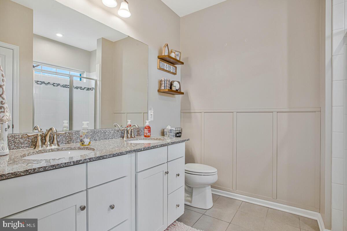 8218 Kippis Road Millersville, MD 21108 - Photo 19 of 40 a bathroom with a granite countertop sink and a mirror