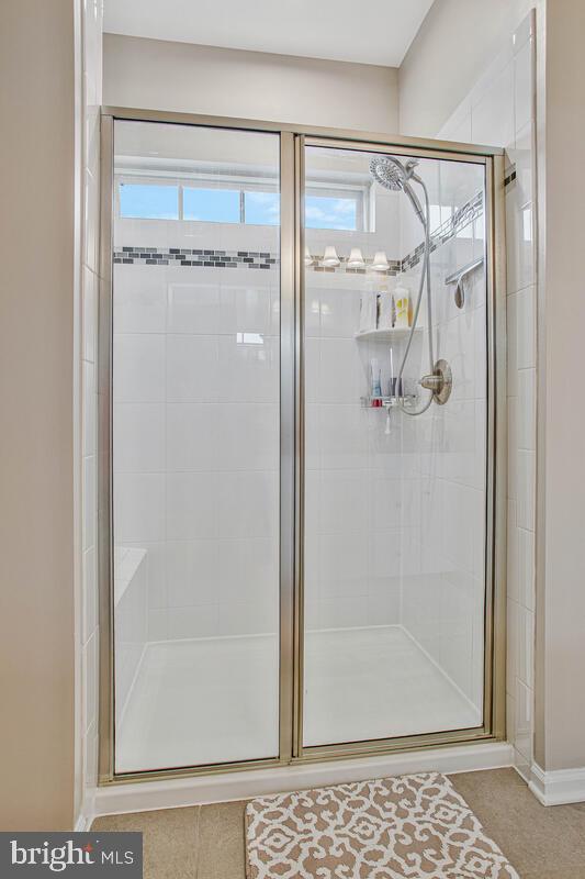 8218 Kippis Road Millersville, MD 21108 - Photo 20 of 40 a bathroom with a glass shower door