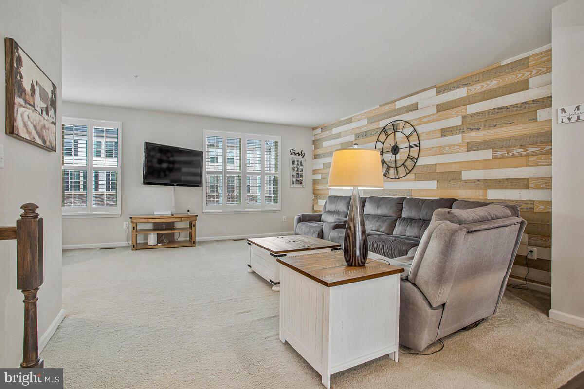 8218 Kippis Road Millersville, MD 21108 - Photo 4 of 40 a view of a livingroom with furniture and a flat screen tv
