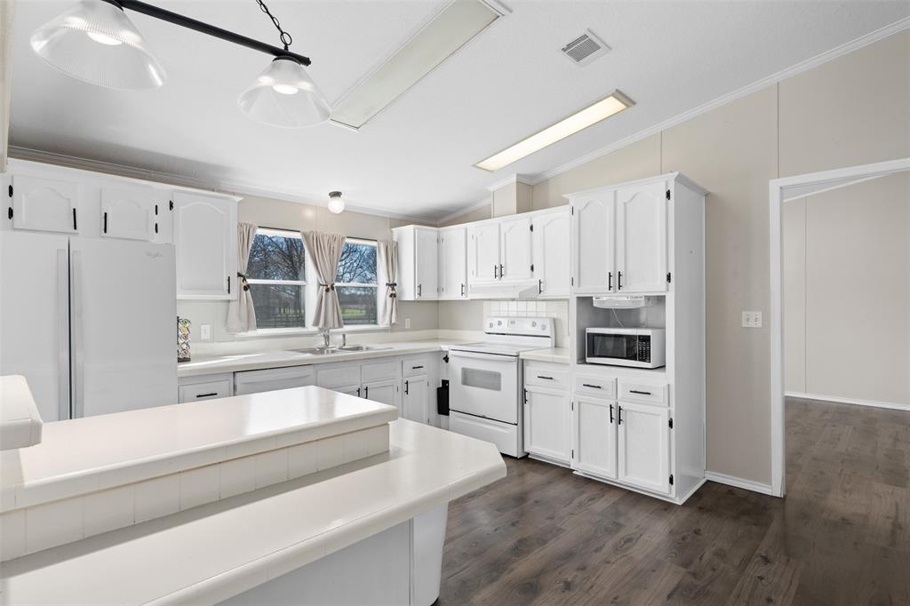 181 Pr 125 Whitney, TX 76692 - Photo 11 of 34 a kitchen with appliances cabinets and a sink