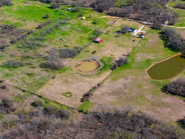 an aerial view of a house with a yard