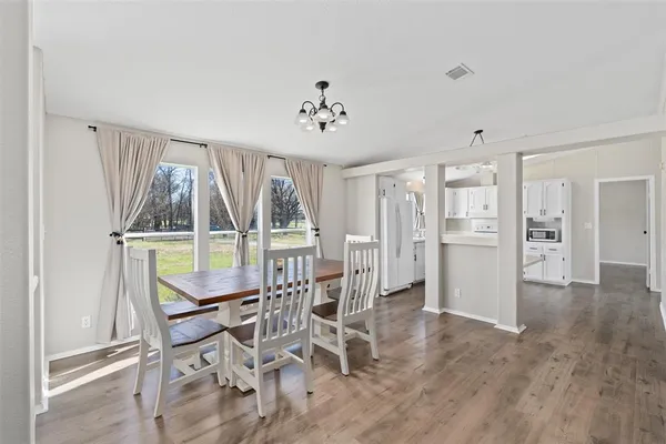 a dining room with furniture and window