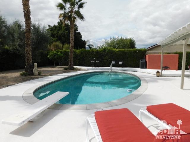 68365 Encinitas Road Cathedral City, CA 92234 - Photo 3 of 25 a view of a swimming pool with an outdoor space and seating area
