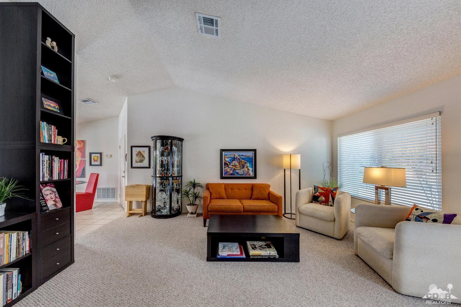 68365 Encinitas Road Cathedral City, CA 92234 - Photo 22 of 25 a living room with furniture and a lamp