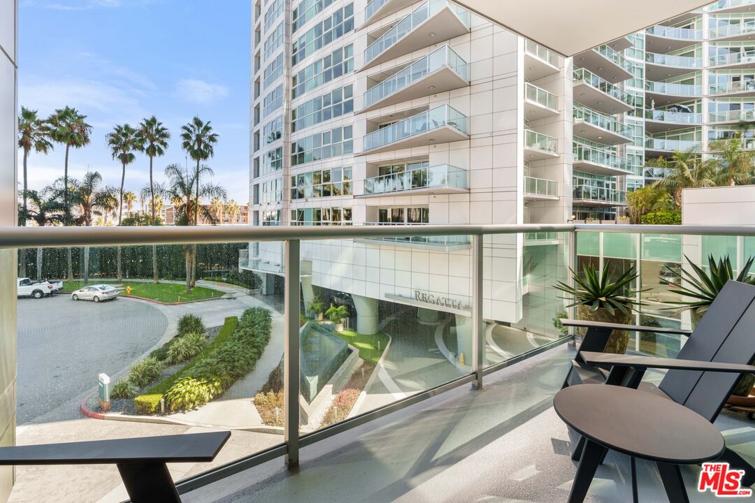 13650 Marina Pointe Drive, Unit 309 Marina del Rey, CA 90292 - Photo 11 of 56 a balcony with table and chairs