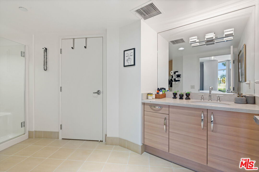 13650 Marina Pointe Drive, Unit 309 Marina del Rey, CA 90292 - Photo 16 of 56 a bathroom with a double vanity sink and mirror