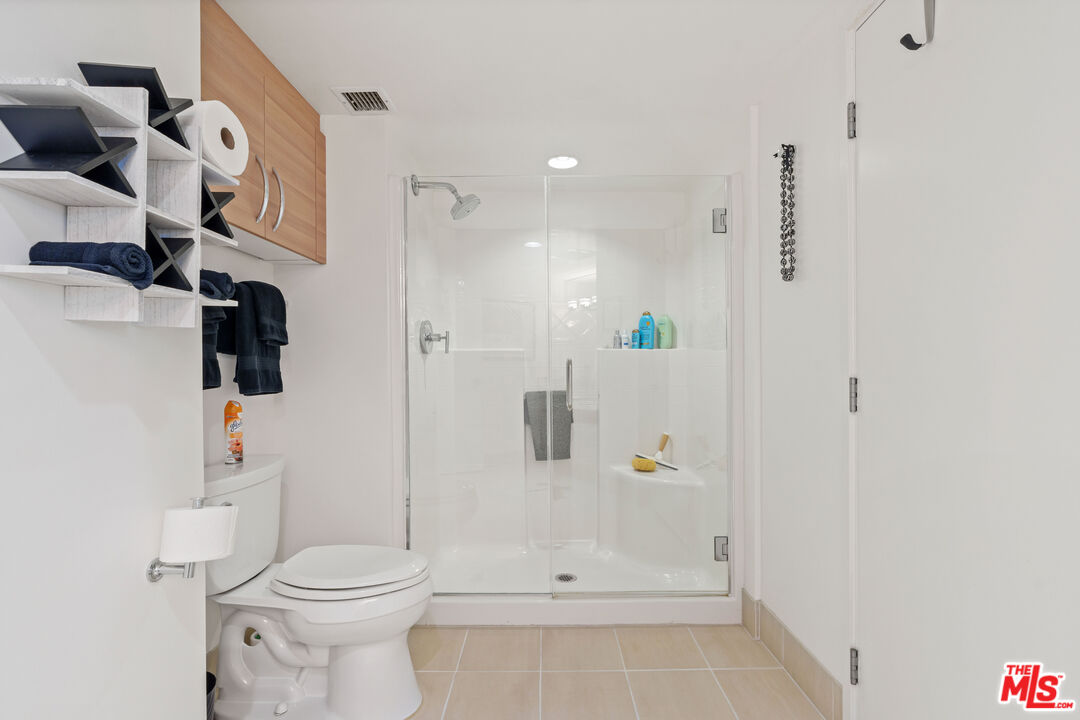 13650 Marina Pointe Drive, Unit 309 Marina del Rey, CA 90292 - Photo 17 of 56 a bathroom with a shower and toilet