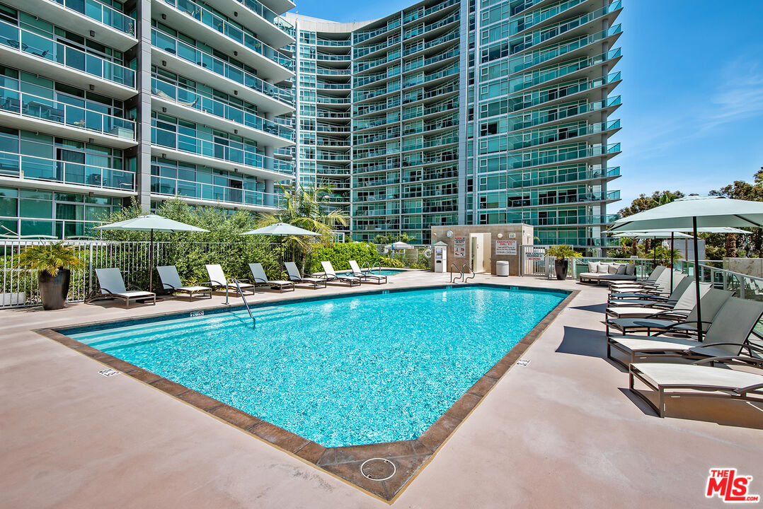 13650 Marina Pointe Drive, Unit 309 Marina del Rey, CA 90292 - Photo 26 of 56 a view of a swimming pool with a patio