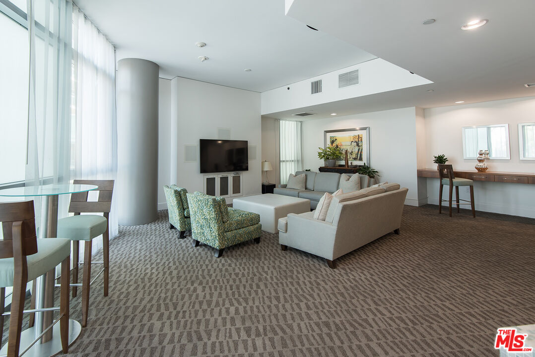 13650 Marina Pointe Drive, Unit 309 Marina del Rey, CA 90292 - Photo 38 of 56 a living room with furniture and a flat screen tv