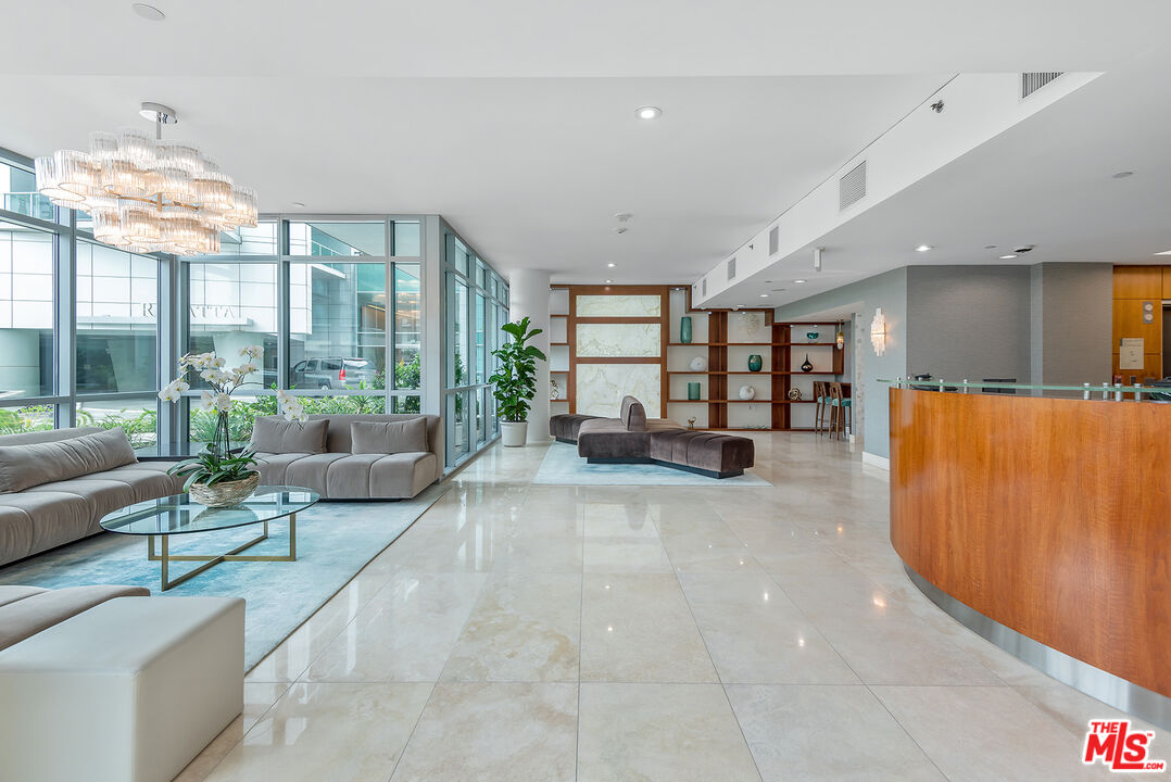 13650 Marina Pointe Drive, Unit 309 Marina del Rey, CA 90292 - Photo 50 of 56 a living room with furniture and a large window