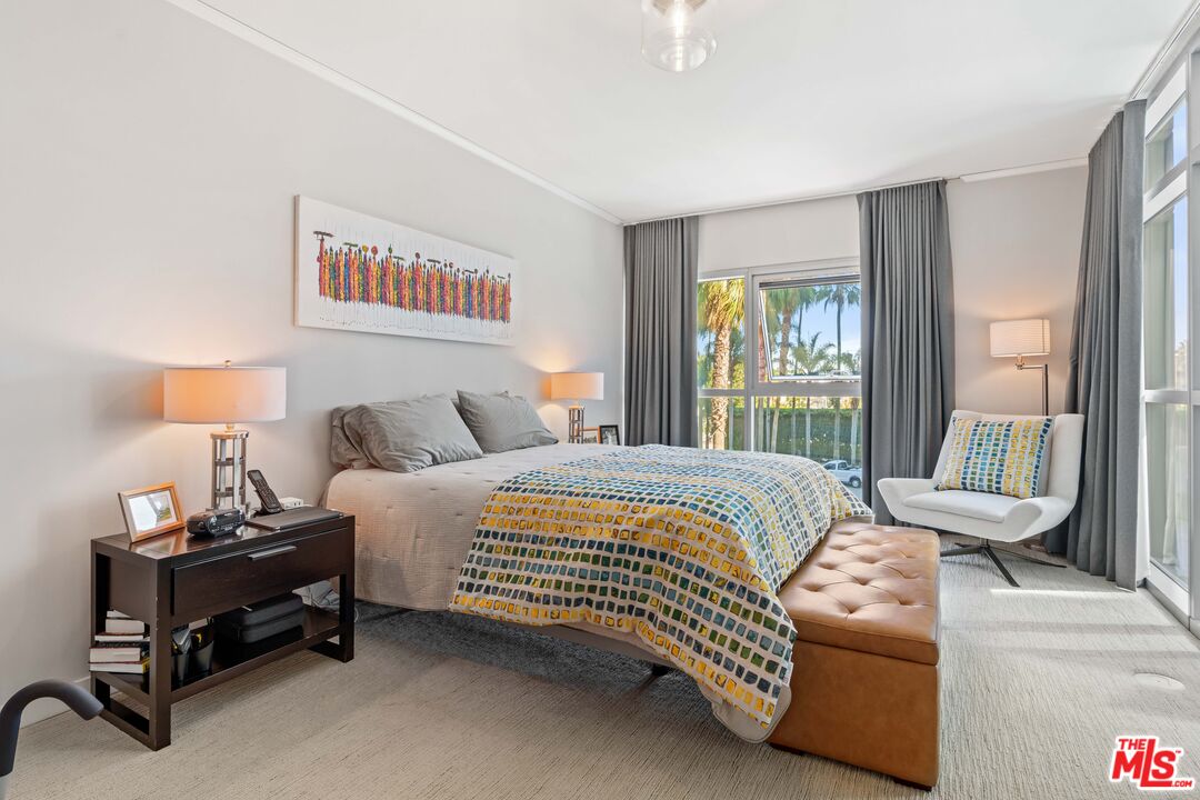 13650 Marina Pointe Drive, Unit 309 Marina del Rey, CA 90292 - Photo 5 of 56 a bedroom with a bed and a lamp next to a window