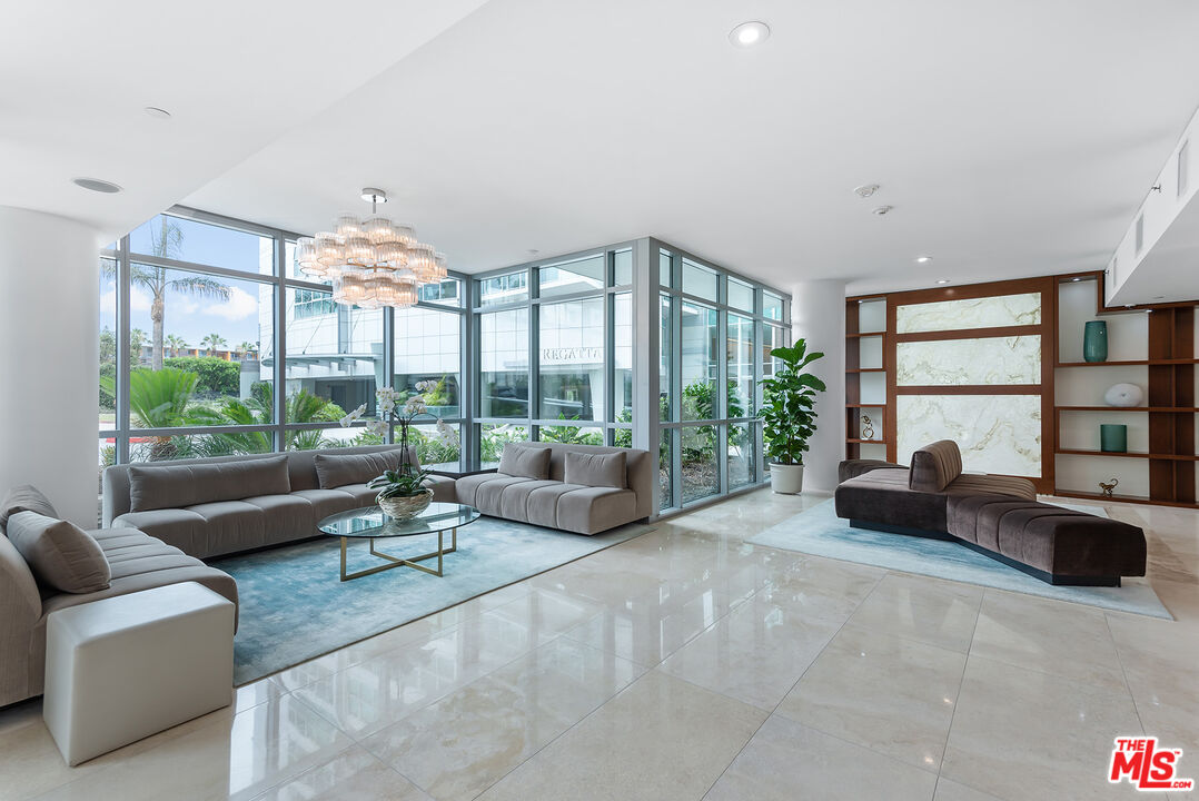 13650 Marina Pointe Drive, Unit 309 Marina del Rey, CA 90292 - Photo 51 of 56 a living room with furniture and a large window