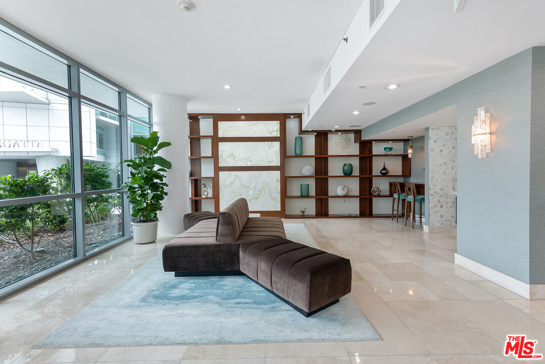 13650 Marina Pointe Drive, Unit 309 Marina del Rey, CA 90292 - Photo 53 of 56 a living room with furniture and a large window