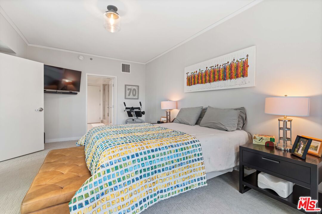 13650 Marina Pointe Drive, Unit 309 Marina del Rey, CA 90292 - Photo 6 of 56 a spacious bedroom with a bed and a tv