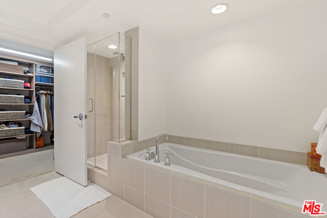13650 Marina Pointe Drive, Unit 309 Marina del Rey, CA 90292 - Photo 10 of 56 a spacious bathroom with a bathtub and a shower